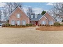 Brick home with gray shutters, landscaping, and a large yard at 3872 Morgans Ridge Dr, Buford, GA 30519