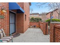 Brick front patio with seating area and access to unit at 2290 Pernoshal Ct, Dunwoody, GA 30338