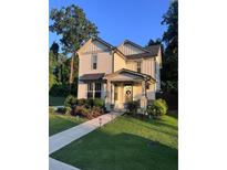 Charming two-story home with landscaped front yard and welcoming front porch at 981 Rittenhouse Way, Atlanta, GA 30316