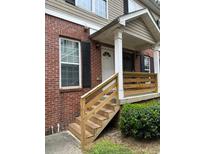 Charming brick townhome featuring a well-maintained exterior and a welcoming front porch entrance at , Marietta, GA 30008