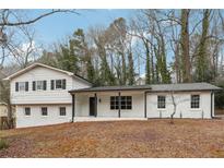 Charming ranch home with freshly painted exterior and landscaped yard at 4651 Lucerne Valley Sw Rd, Lilburn, GA 30047