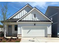 Charming single-story home with white siding, black roof, attached garage, and well-manicured lawn at 1818 Butterfly Way, Marietta, GA 30066