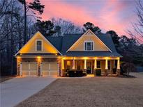 Beautiful two-story house with a three-car garage, and charming front porch at 952 Sweetwater Bridge Cir, Douglasville, GA 30134