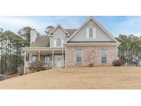 Two story brick home with covered porch and large yard at 42 Oak Leaf Dr, Dallas, GA 30157