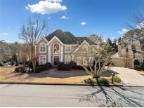 Two-story house with stone accents and landscaping at 110 Pro Ter, Johns Creek, GA 30097