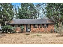 Brick ranch house with mature trees and a large yard at 1491 Boulderwoods Se Dr, Atlanta, GA 30316