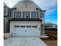 Charming two-story white brick home featuring a spacious two-car garage and beautifully contrasting shutters at 3990 Cavalier Way, Duluth, GA 30097