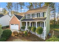 Charming two-story home with a brick-accented garage and well-maintained front yard landscaping at 1019 Braelin Ct, Woodstock, GA 30189