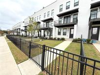 Modern townhouses with white brick exteriors, balconies, and black fences at 1031 Robert Smalls Way, Atlanta, GA 30318