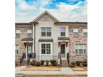 Brick front of charming townhome with steps and small landscaping at 2071 Glenview Park Cir, Duluth, GA 30097