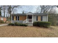 Gray brick ranch house with a red door and small front yard at 1876 Selwyn Dr, Decatur, GA 30035