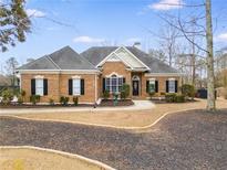 Brick house with landscaped yard and walkway at 9415 Grande Dr, Winston, GA 30187