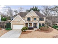 Two-story house with stone accents and a landscaped yard at 12265 Magnolia Crescent Dr, Roswell, GA 30075