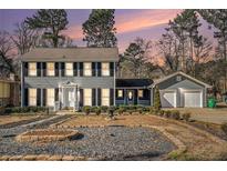 Two-story house with gray siding, shutters, and a two-car garage at 501 Fond Du Lac Dr, Stone Mountain, GA 30088