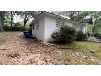 White house exterior with landscaping and partially visible yard at 6194 Polly Anna Se Ave, Covington, GA 30014