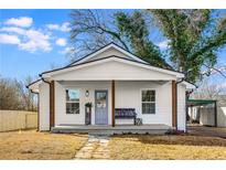 Charming white cottage with a covered porch and landscaped yard at 363 Roselane Nw St, Marietta, GA 30060