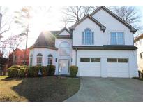 Charming two-story stucco home with a two-car garage, arched windows, and well-maintained landscaping at 4259 Creek Haven Dr, Marietta, GA 30062