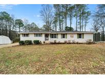 Ranch style home with brick facade, mature trees, and a spacious yard at 5839 Darry Cir, Norcross, GA 30093