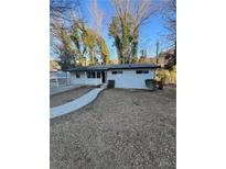 Ranch style home with white exterior, landscaped yard, and walkway at 2529 Dale Creek Nw Dr, Atlanta, GA 30318