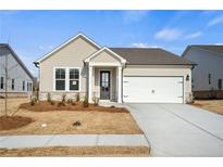Charming single-story home with a two-car garage and professionally landscaped front yard at 1783 Juniper Berry Way, Loganville, GA 30052