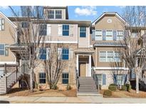 Brick front exterior of townhome with stairs and landscaping at 4194 Integrity Way, Powder Springs, GA 30127