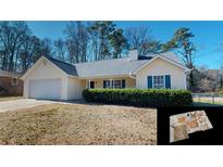 One-story house with attached garage and manicured lawn at 4002 Cheoah Dr, Douglasville, GA 30135