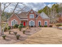 Brick house with red door, landscaped yard at 3640 Rolling Creek Dr, Buford, GA 30519