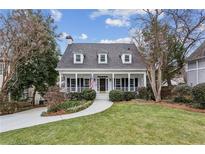 Two-story house with white exterior, front porch, and landscaped lawn at 975 Seaboard Nw Ave, Atlanta, GA 30318