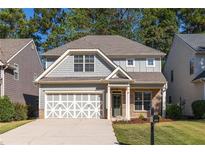 Two-story house with gray siding, brick accents, and a two-car garage at 230 Ascott Ln, Woodstock, GA 30189