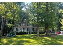 Brick house with green shutters, landscaping, and a spacious yard at 714 Weatherborn Pl, Stone Mountain, GA 30083