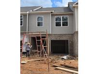 Townhome exterior features gray siding and brick foundation at 2804 Lillian Ln, Douglasville, GA 30135