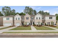 New townhome community with three-story homes and attached garages at 451 Payne Dr, Mcdonough, GA 30253