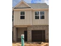 New construction townhouse with brick and board and batten and an attached garage at 2808 Lillian Ln, Douglasville, GA 30135
