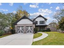 Two-story home with gray and white siding, two-car garage, and landscaped lawn at 1849 8Th St, Atlanta, GA 30341