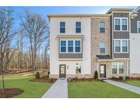 Charming new construction townhome with manicured lawn and tree-lined surroundings at 200 Wallace St, Fayetteville, GA 30214