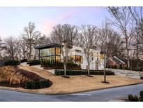 Modern two-story home with a sleek design and landscaped yard at 14 Lake Forrest Ne Ln, Atlanta, GA 30342