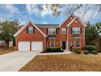 Brick two-story house with a two-car garage and landscaped lawn at 6920 Talkeetna Ct, South Fulton, GA 30331