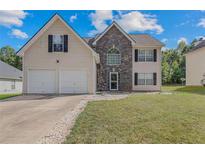 Two-story house with stone accents and a two-car garage at 240 Creekview Blvd, Covington, GA 30016