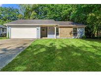 Newly renovated light blue house with a white garage door and a well-maintained lawn at 8663 Cedar Creek Rdg, Riverdale, GA 30274
