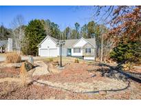 Ranch home with two-car garage and landscaped front yard at 202 Greentree Trl, Temple, GA 30179