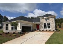 Charming one-story home featuring brick accents, a red front door, attached garage, and freshly landscaped front yard at 15 Cambridge Ln, Dallas, GA 30157