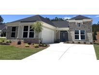 Charming single-story home featuring a mix of brick and siding, complemented by a well-manicured lawn and an attached garage at 15 Cambridge Ln, Dallas, GA 30157