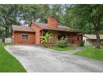 Charming one-story home with wood siding, stone accents, covered porch, and well-maintained front yard at 6698 Cameron Rd, Morrow, GA 30260