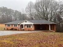 Brick ranch house with carport and large yard at 4890 Prince Se Rd, Smyrna, GA 30082