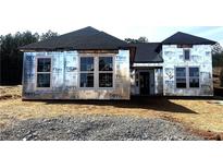 Unfinished construction of a home's exterior, showcasing its architectural structure and design prior to its completion at 126 Laurel Farms Ln, Dallas, GA 30157