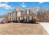 Two story brick home with landscaping and a large yard at 2155 Washington Dr, Douglasville, GA 30135