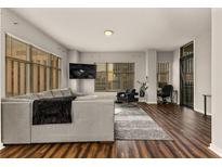 Spacious living room with hardwood floors, large windows, and modern furniture at 565 Peachtree Ne St # 804, Atlanta, GA 30308