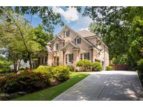 Brick two-story home with landscaped yard and driveway at 3173 Woodrow Ne Way, Brookhaven, GA 30319