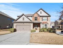 Two-story brick home with a large driveway and landscaping at 2471 Pinehurst Rdg, Atlanta, GA 30337