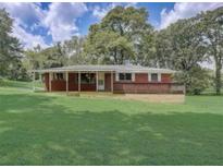 Brick ranch house with a large yard and covered deck at 794 Old Allatoona Se Rd, Cartersville, GA 30121